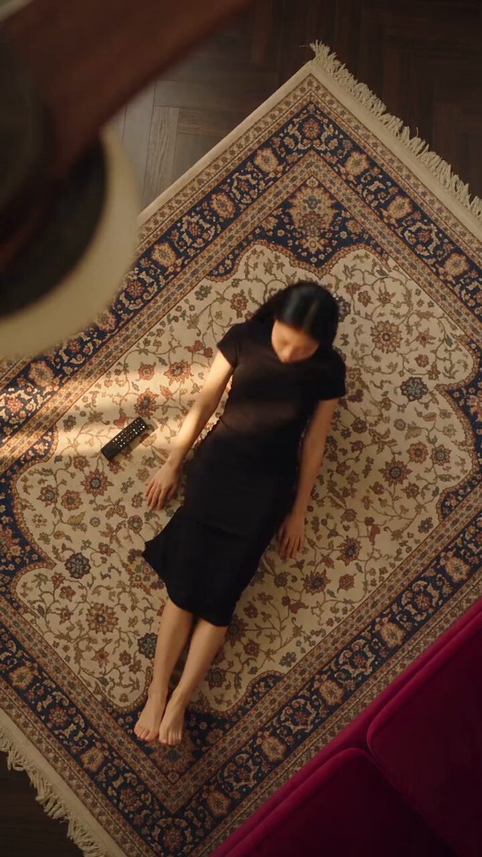 Overhead shot of woman with transitioning outfits on rug